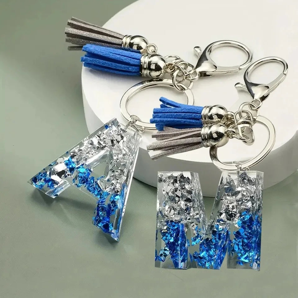 Llaveros creativos de resina de 26 letras con borla, accesorios de moda con iniciales, lentejuelas, color azul y plateado, colgante para bolso
